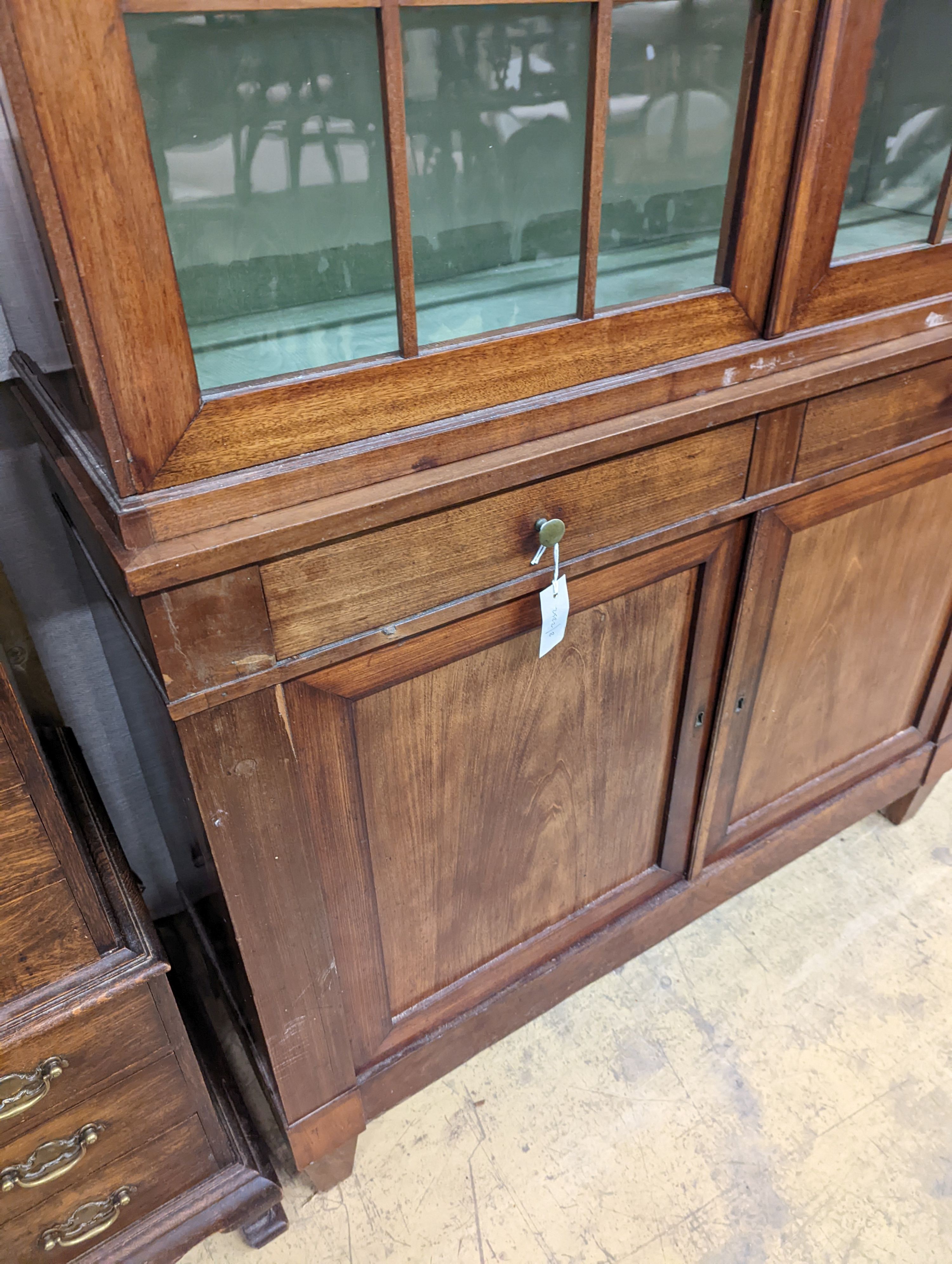 A 19th century Continental mahogany glazed side cabinet, width 116cm, depth 40cm, height 166cm